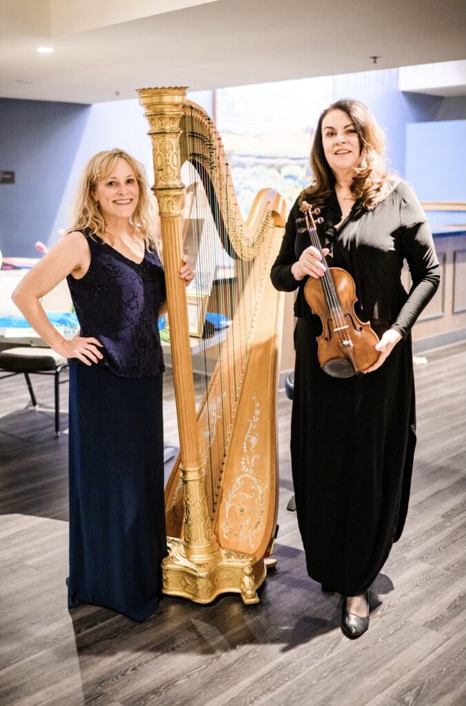 Captivating image of Mary Law, Reno Tahoe's premier harpist, enchanting guests with her mesmerizing melodies at a wedding ceremony.